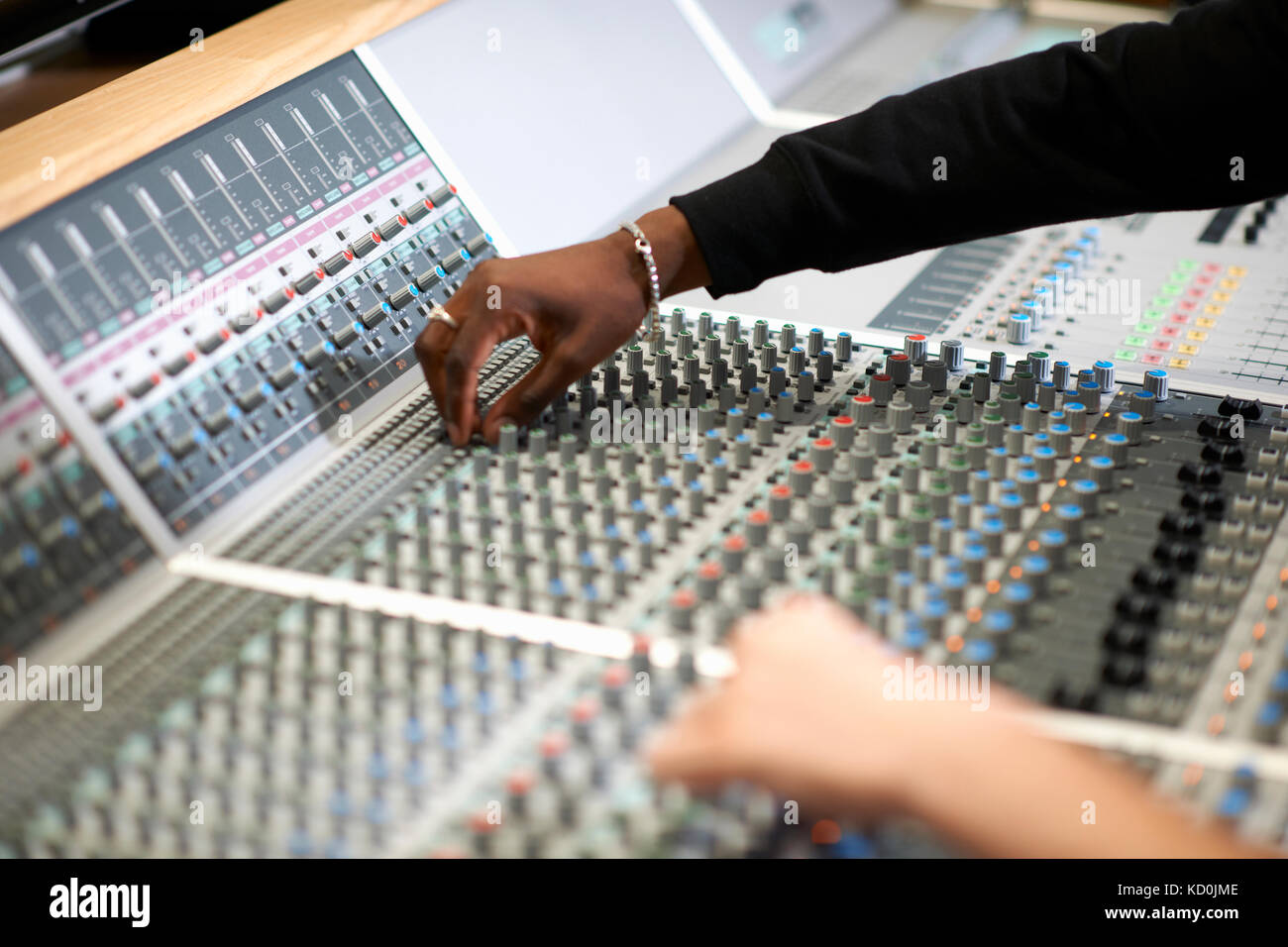 Hands of male college students at sound mixer in recording studio Stock ...