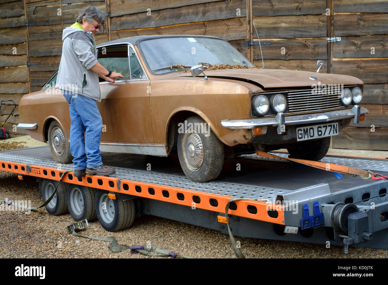 a barn find of a british sunbeam rapier car from the 1970s ready for restoration as a project is loaded onto a trailer Stock Photo