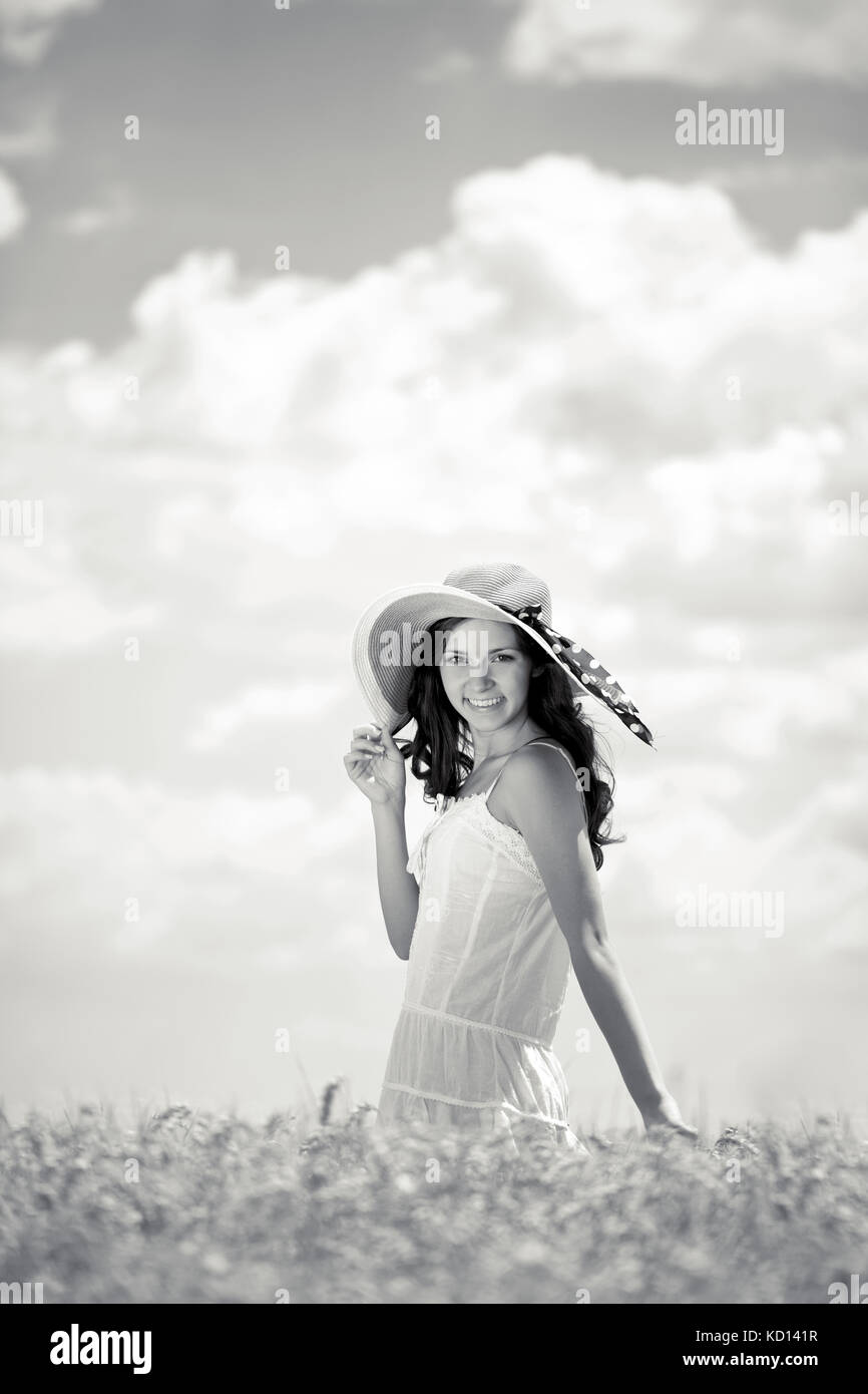 Young smiling woman standing in wheat field, black and white Stock ...