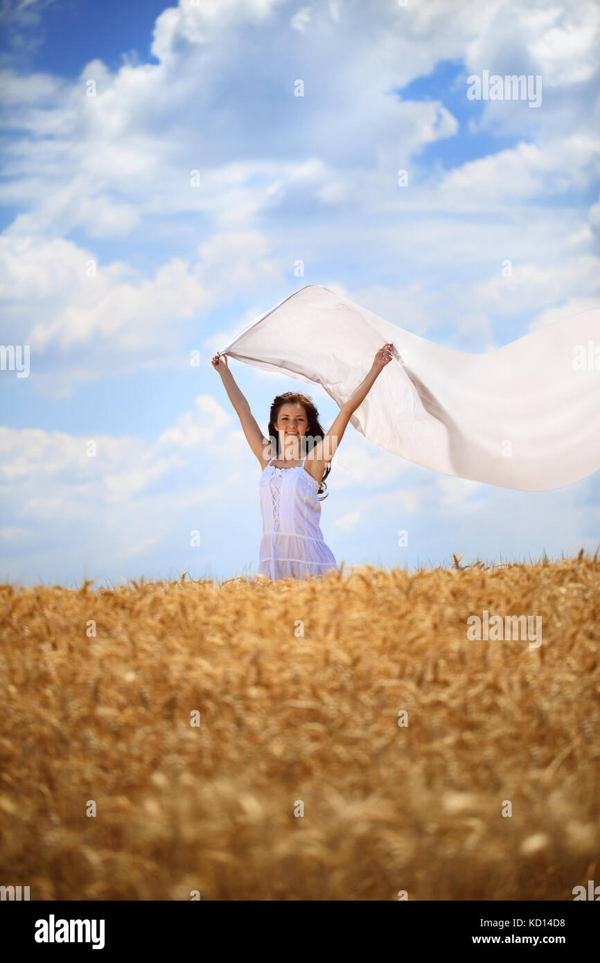 Young woman with white scarf on wind standing in wheat field Stock ...