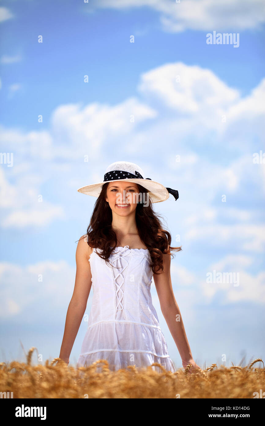 Young woman in golden wheat field enjoying in summer day Stock Photo ...