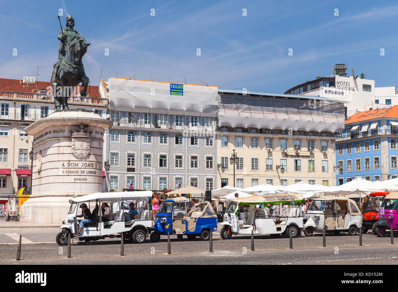 Lisbon, Portugal - August 12, 2017: Tuk Tuk taxi cabs of Lisbon stand on a city square with tourists as a passengers. Piaggio Ape three-wheeled light  Stock Photo