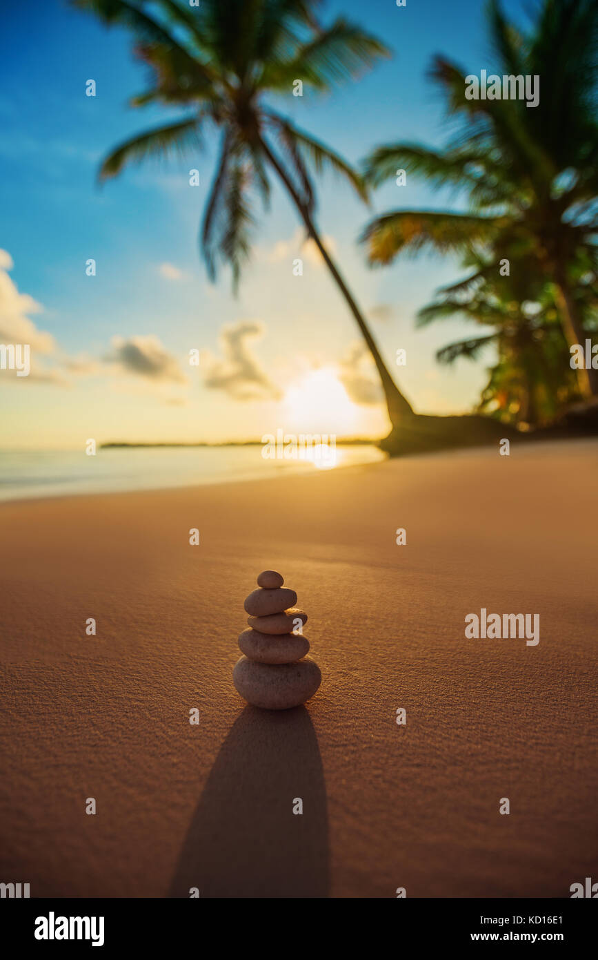 Stones balance on beach, tropical sunrise shot Stock Photo