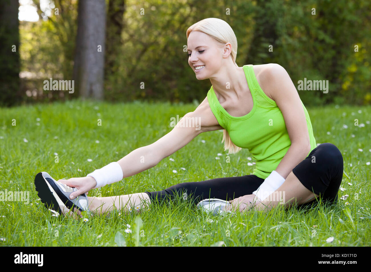Sportive woman sitting stretching hi-res stock photography and images ...