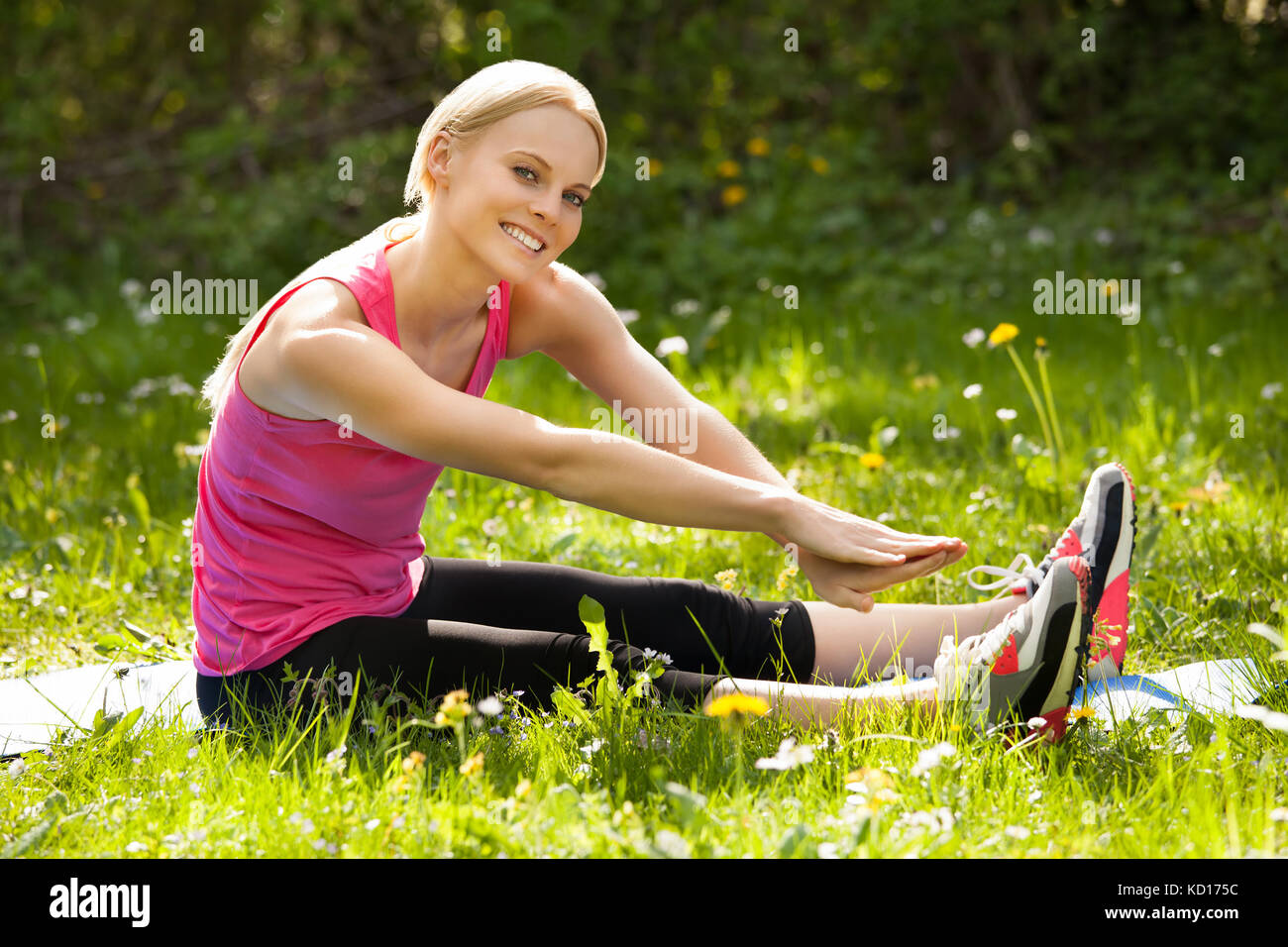 Blonde woman stretching hi-res stock photography and images - Alamy