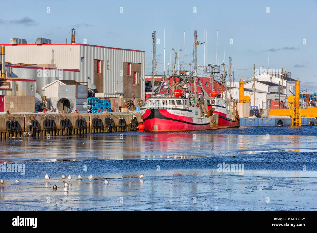 Fishing boats tied up at wharf in winter, Glace Bay, Nova Scotia, Canada Stock Photo