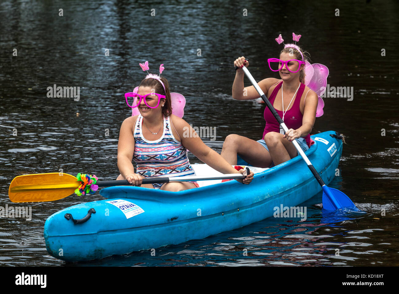 Girls in butterfly mask canoeing river Otava, Summer vacation, Czech Republic young women Stock Photo