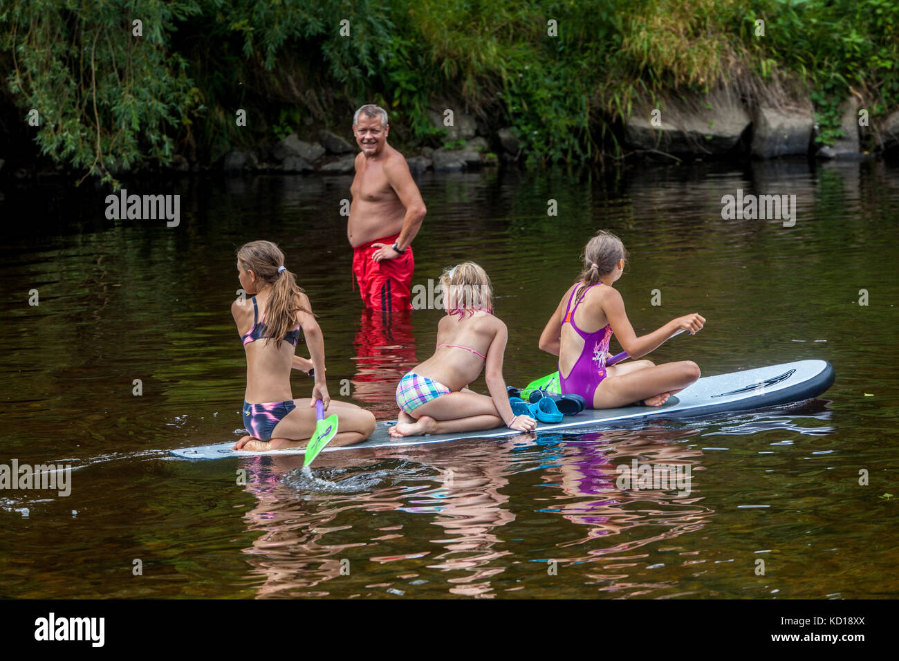 Three girls, paddleboarding,  Otava river, Vacations in summer, zech Republic girls Stock Photo