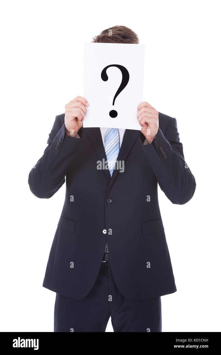 Portrait Of Businessman Holding Question Mark Sign In Front Of Face Stock Photo