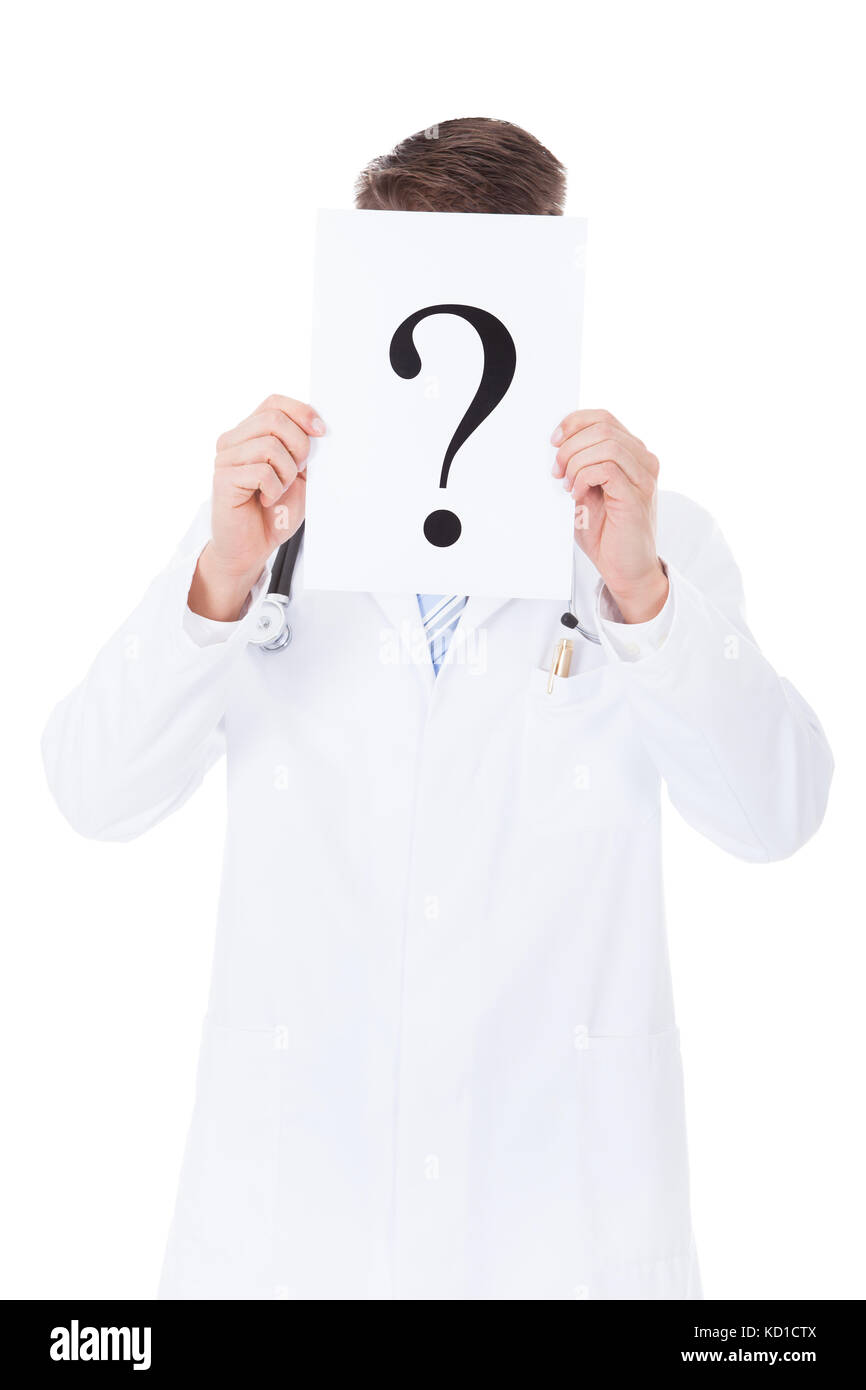 Close-up Of Doctor Holding Question Mark Sign In Front Of Face Stock Photo