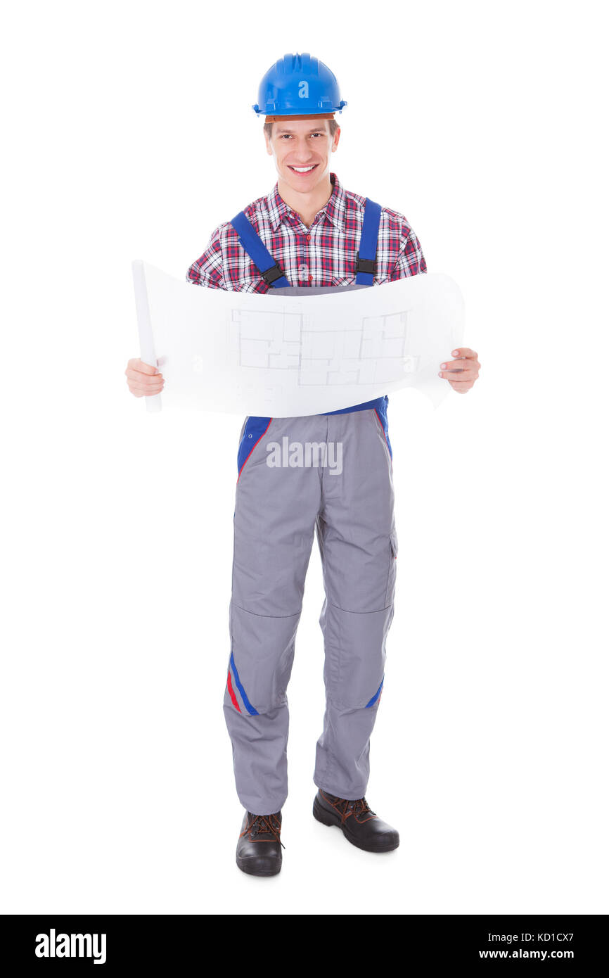 Portrait Of Young Male Architect Analyzing Blueprint Over White Background Stock Photo