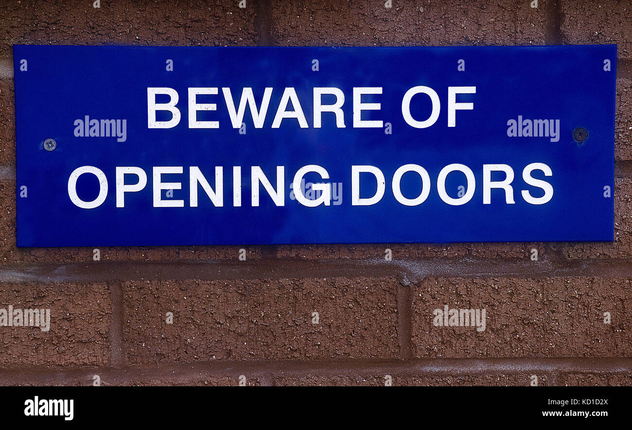beware of opening doors sign Stock Photo