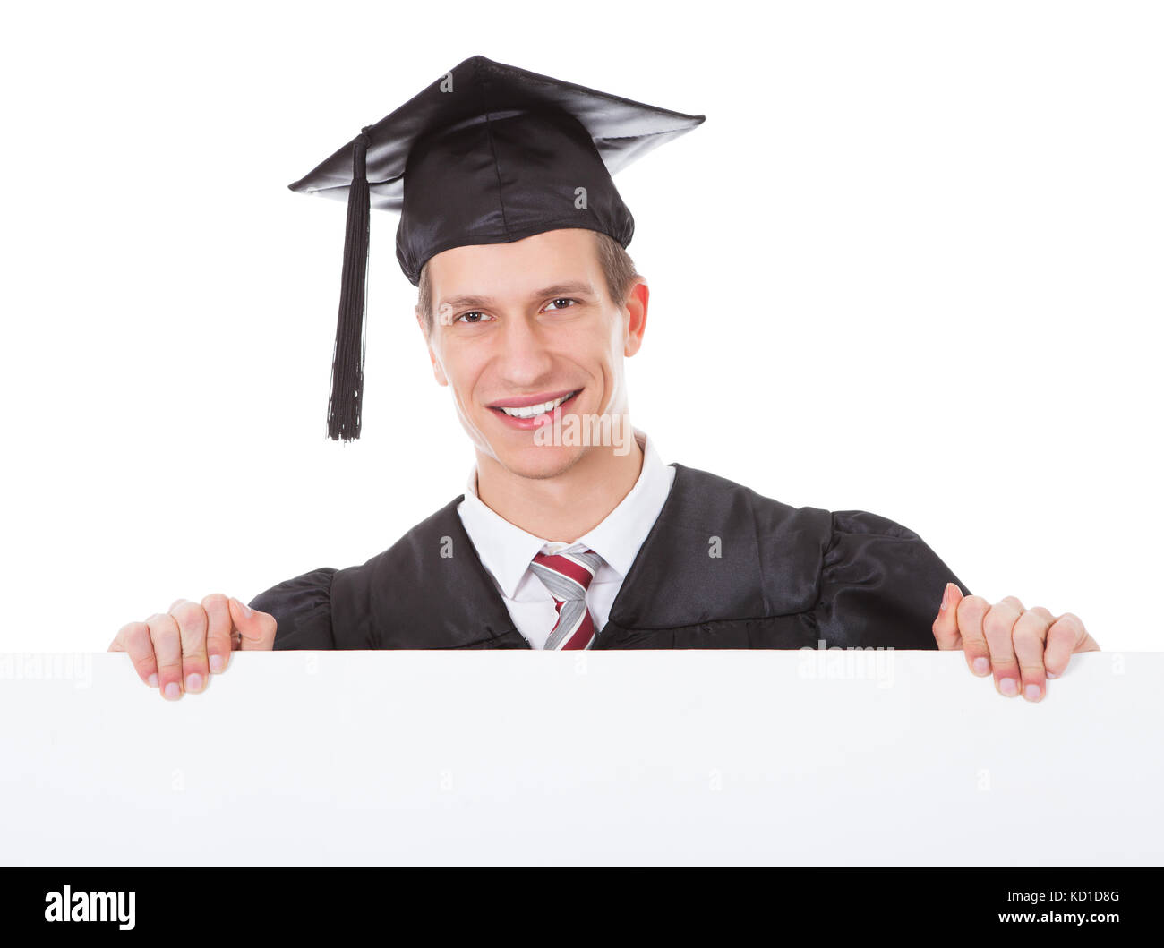 Young Graduate Man Holding White Billboard Over White Background Stock Photo