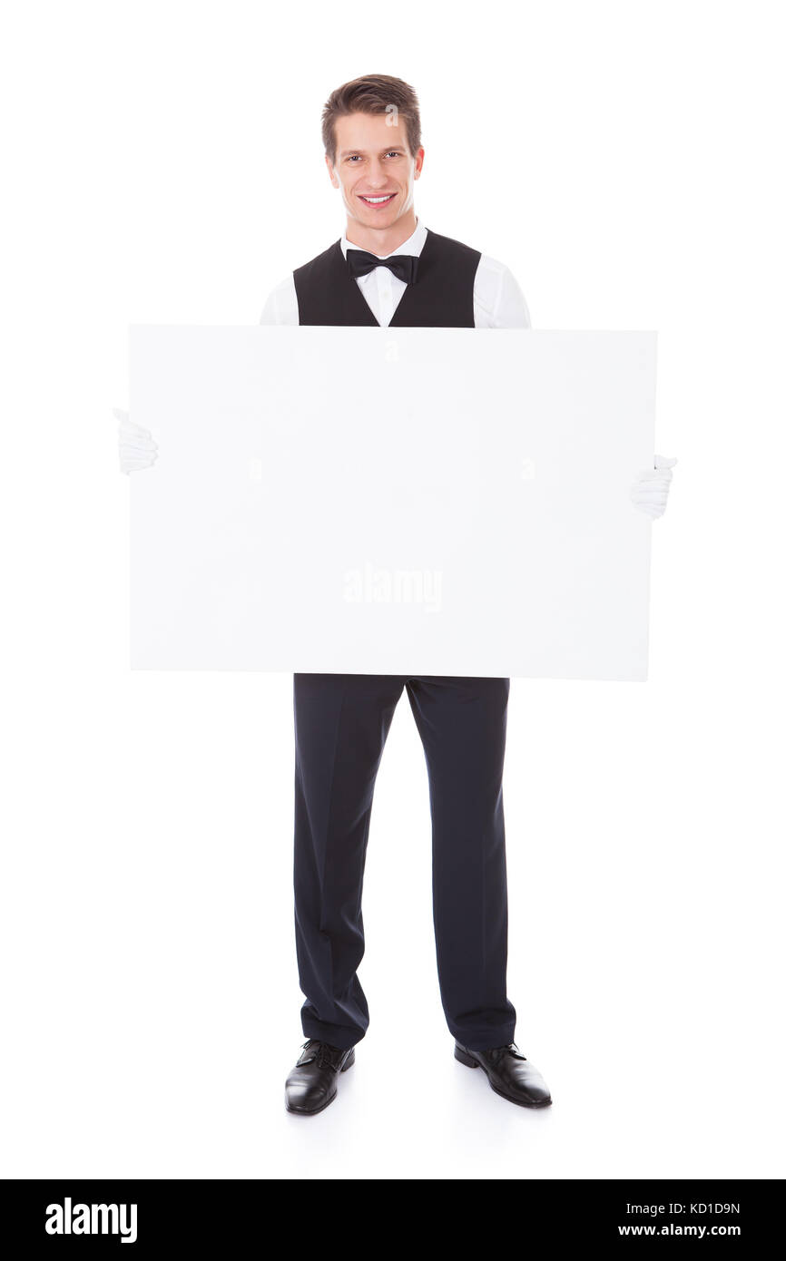 Male Waiter Holding White Billboard Over White Background Stock Photo