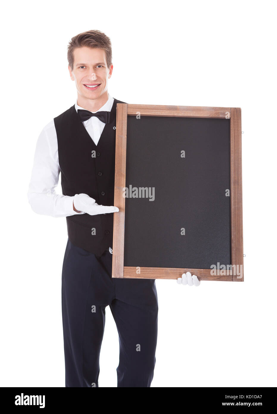Young Male Waiter Holding Chalkboard Over White Background Stock Photo