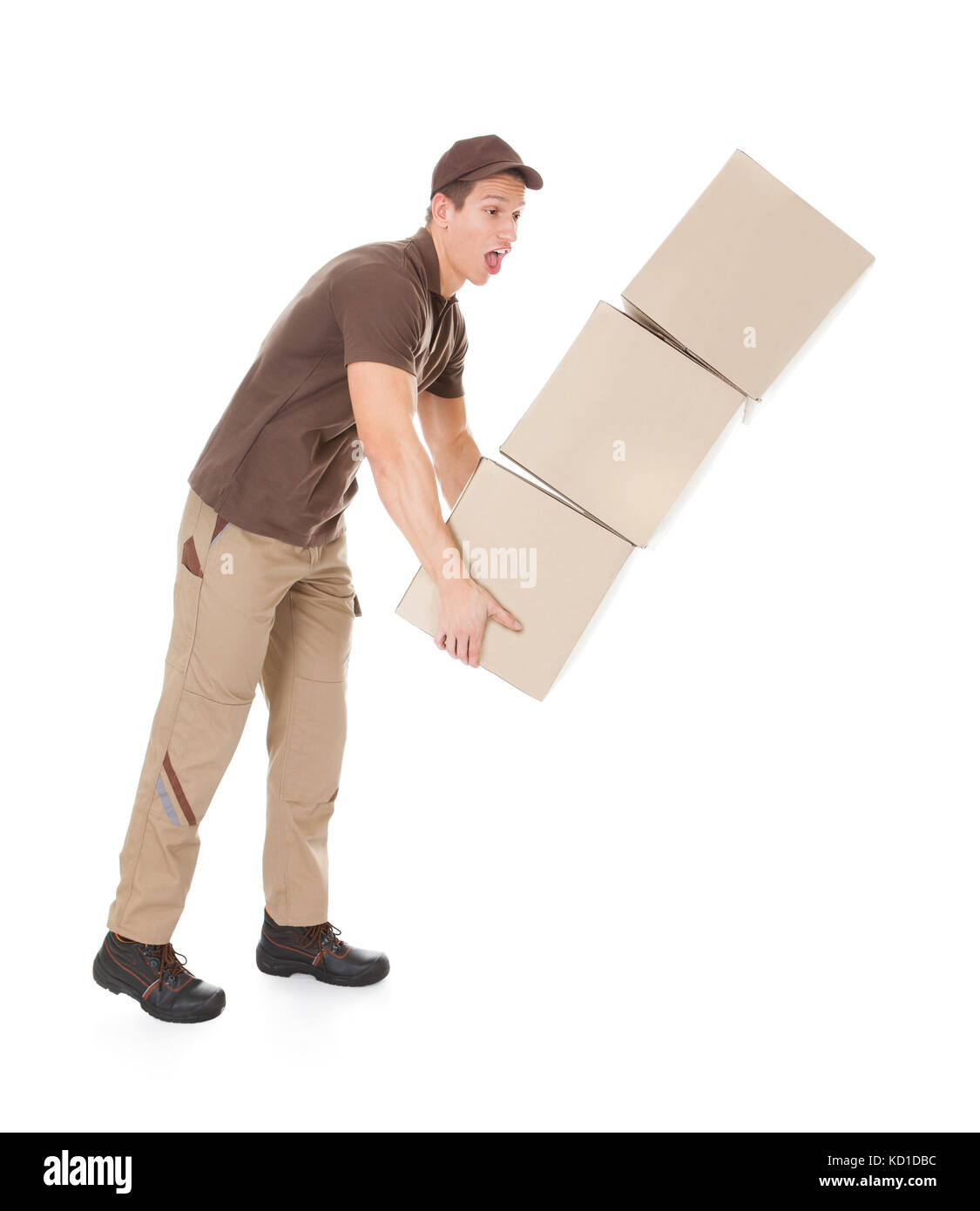 Young Delivery Man With Falling Stack Of Boxes Over White Background Stock Photo