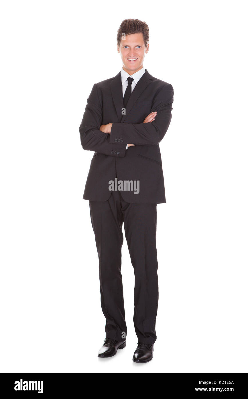Happy Young Businessman With Arm Crossed Standing On White Background ...