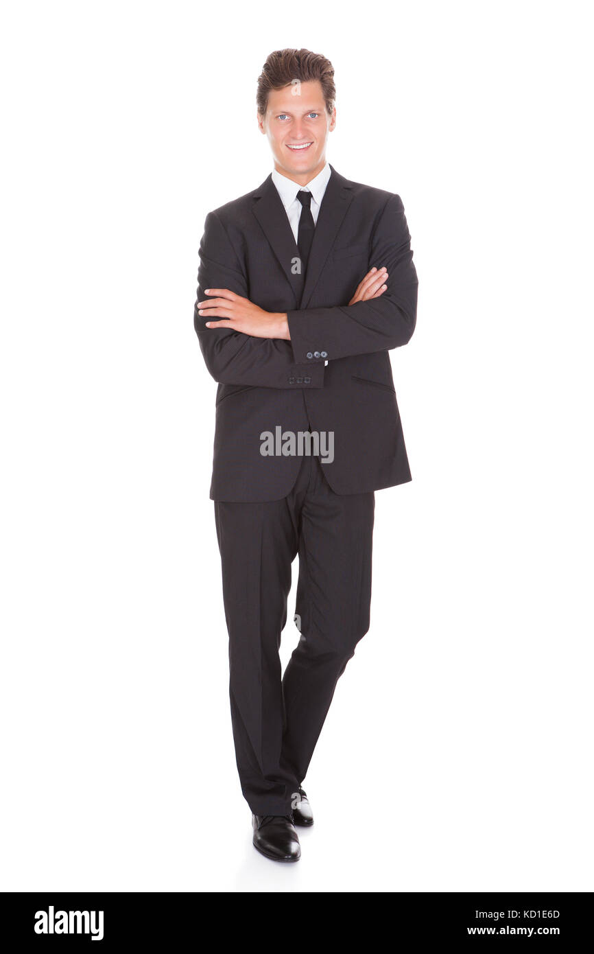 Happy Young Businessman With Arm Crossed Standing On White Background ...