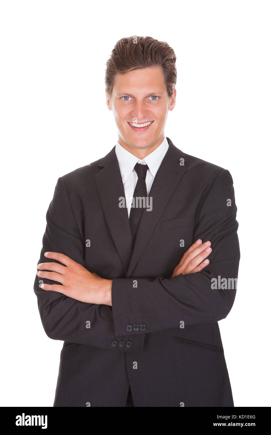 Happy Young Businessman With Arm Crossed Standing On White Background ...