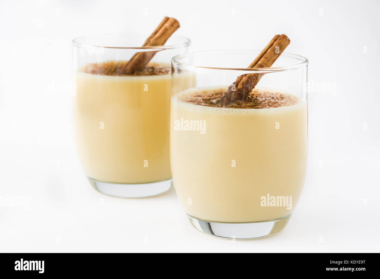 Homemade eggnog with cinnamon isolated on white background. Typical Christmas dessert Stock