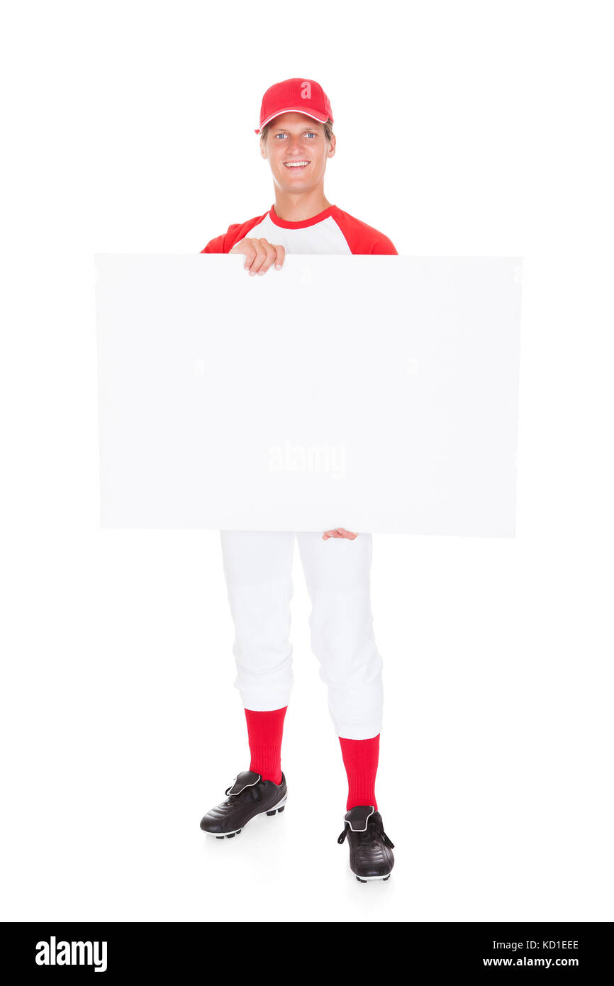 Baseball Player Holding Blank Placard Over White Background Stock Photo