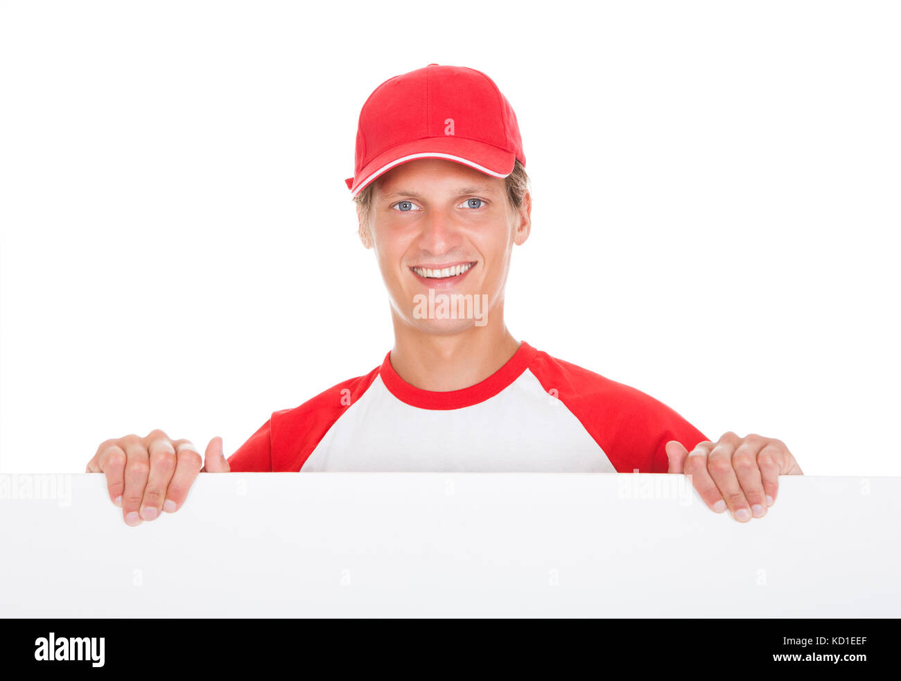 Baseball Player Holding Blank Placard Over White Background Stock Photo