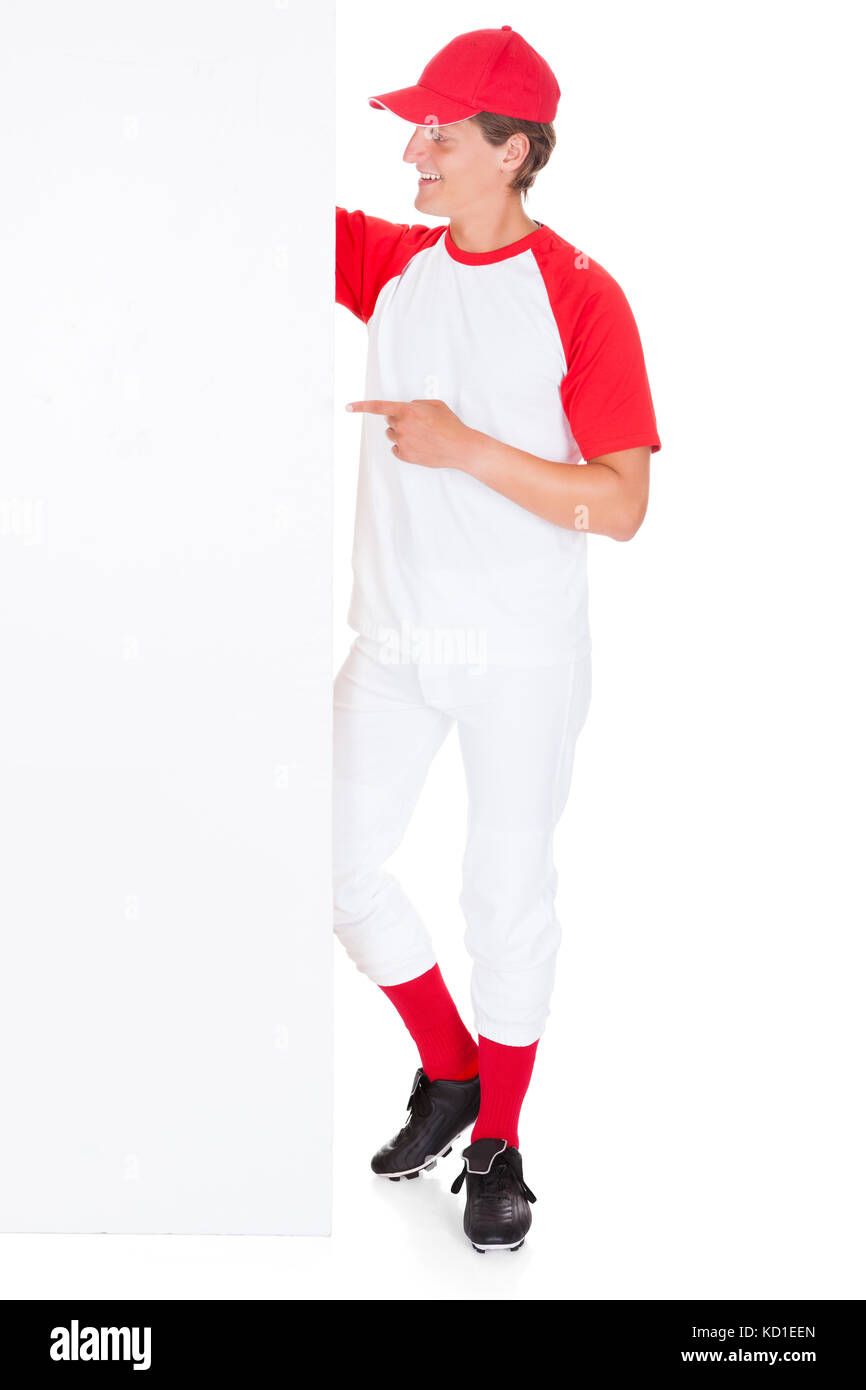 Baseball Player Holding Blank Placard Over White Background Stock Photo