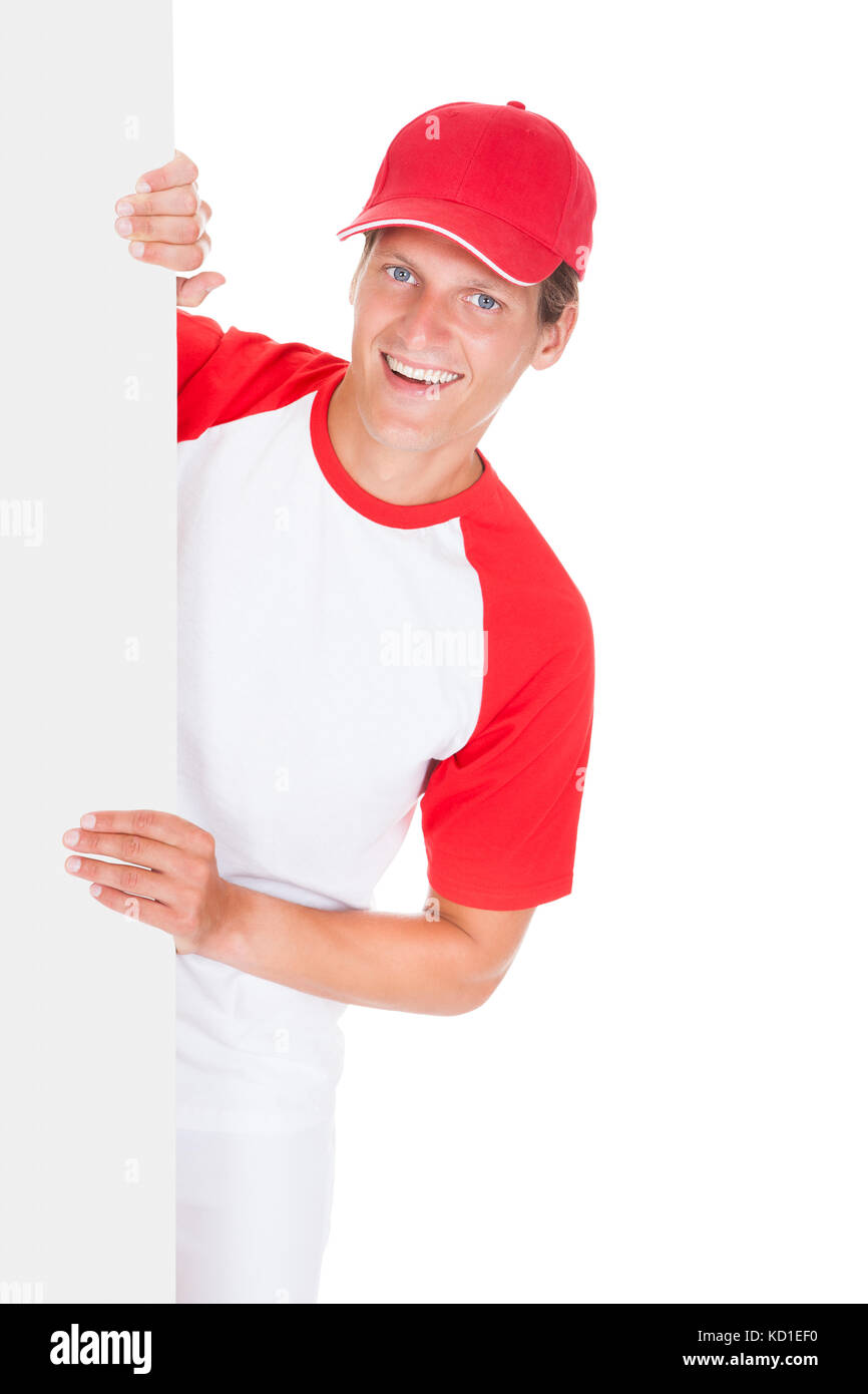 Baseball Player Holding Blank Placard Over White Background Stock Photo
