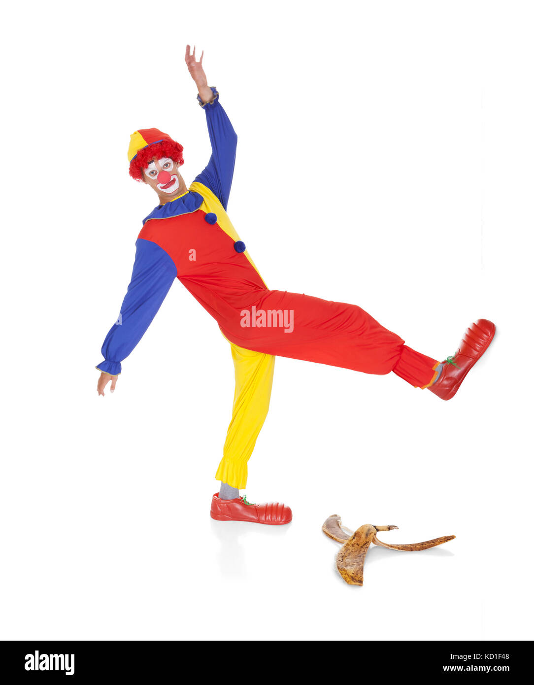 Joker About To Fall On Banana Skin Over White Background Stock Photo