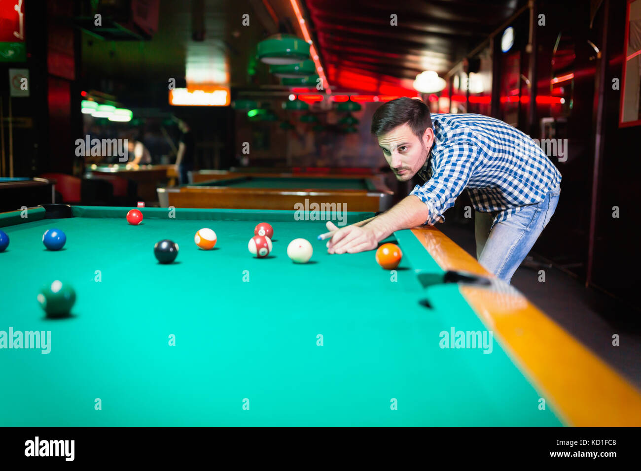 Hansome man playing pool in bar alone Stock Photo