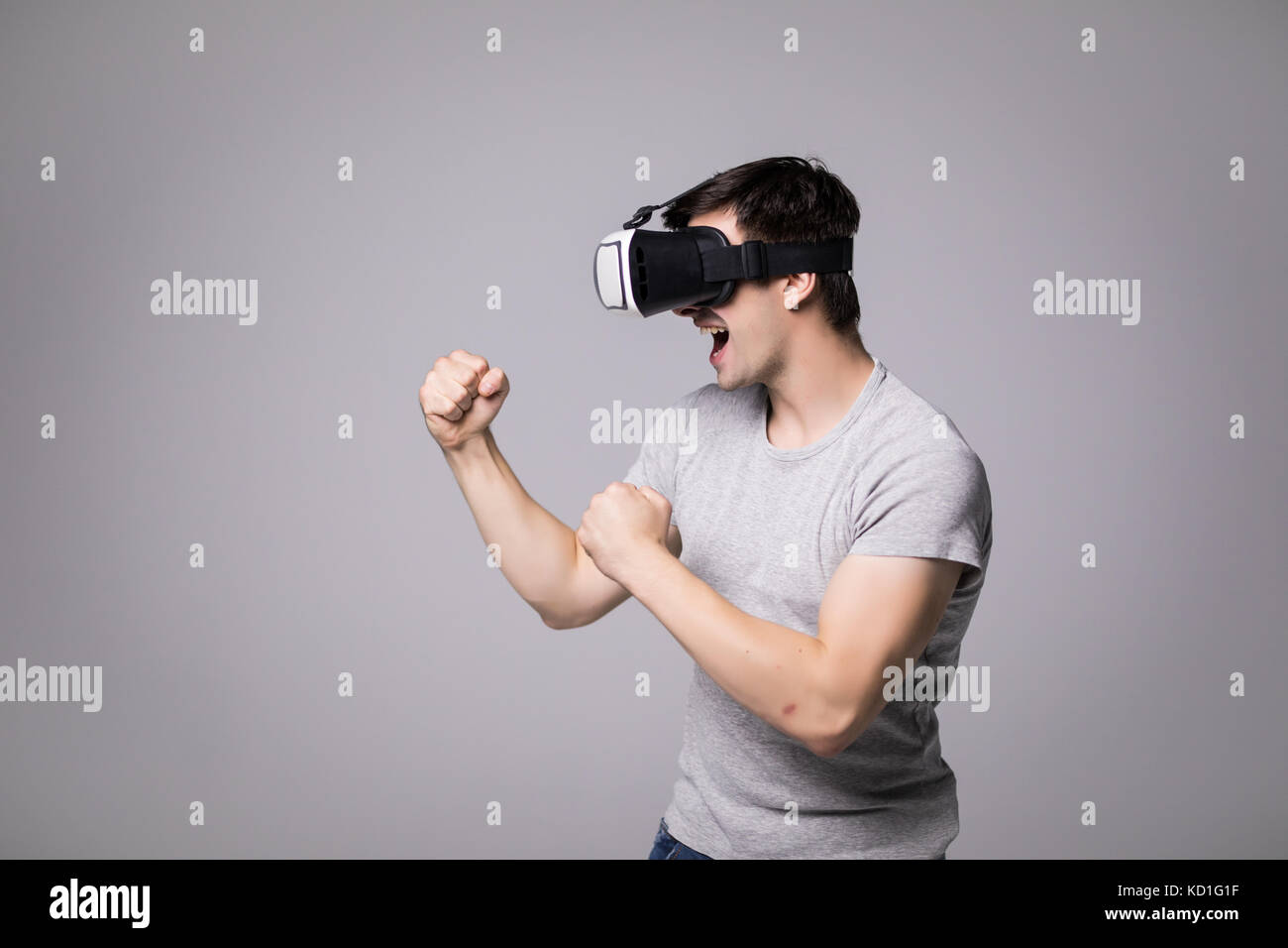 Man with virtual reality headset playing a sport fight video game ...