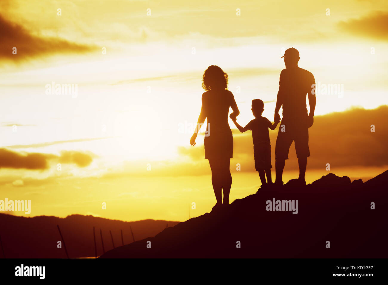 Family son sunset silhouettes sky Stock Photo