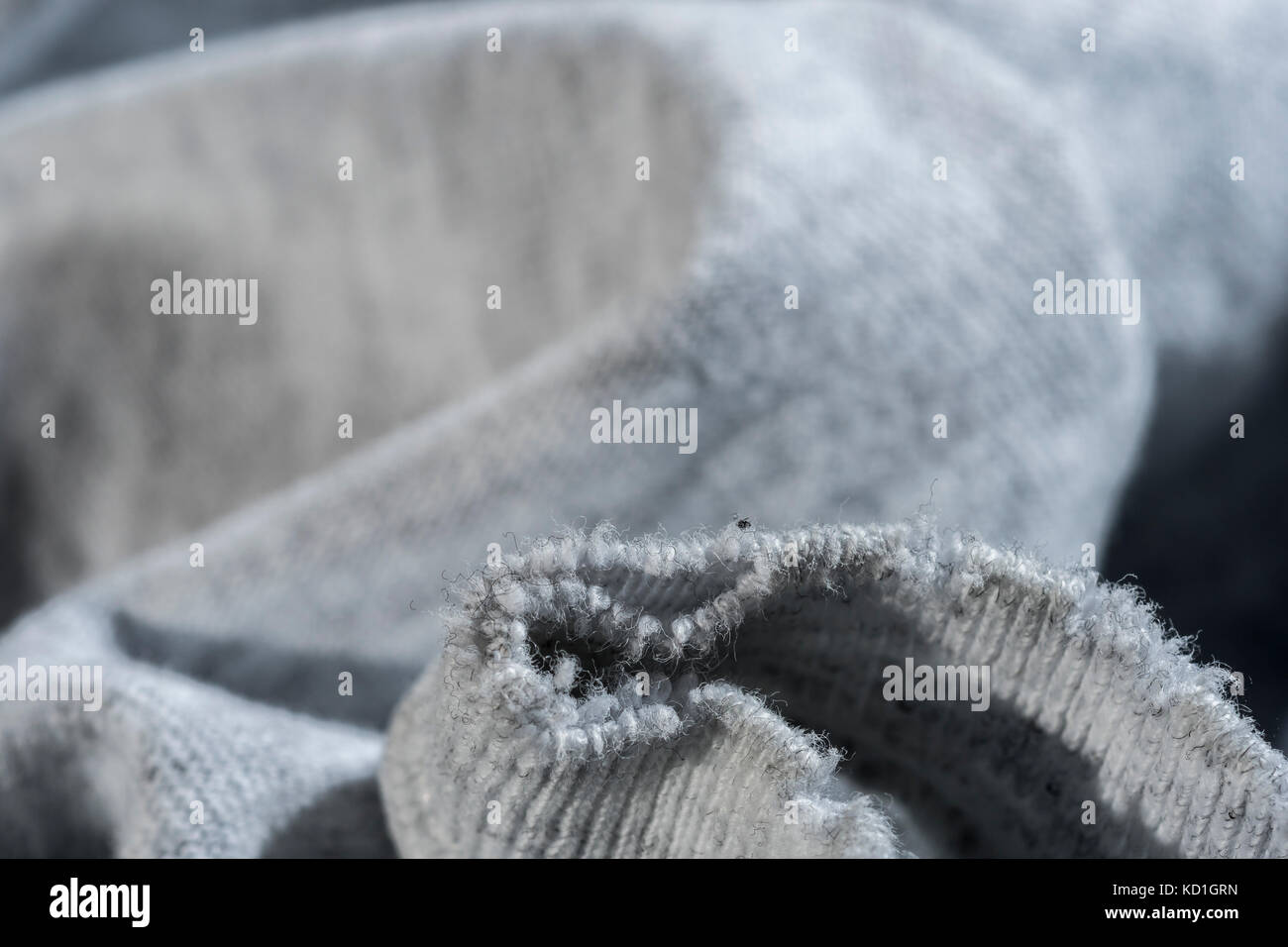 Close-up of the worn neckline of an old threadbare t-shirt - metaphor ...