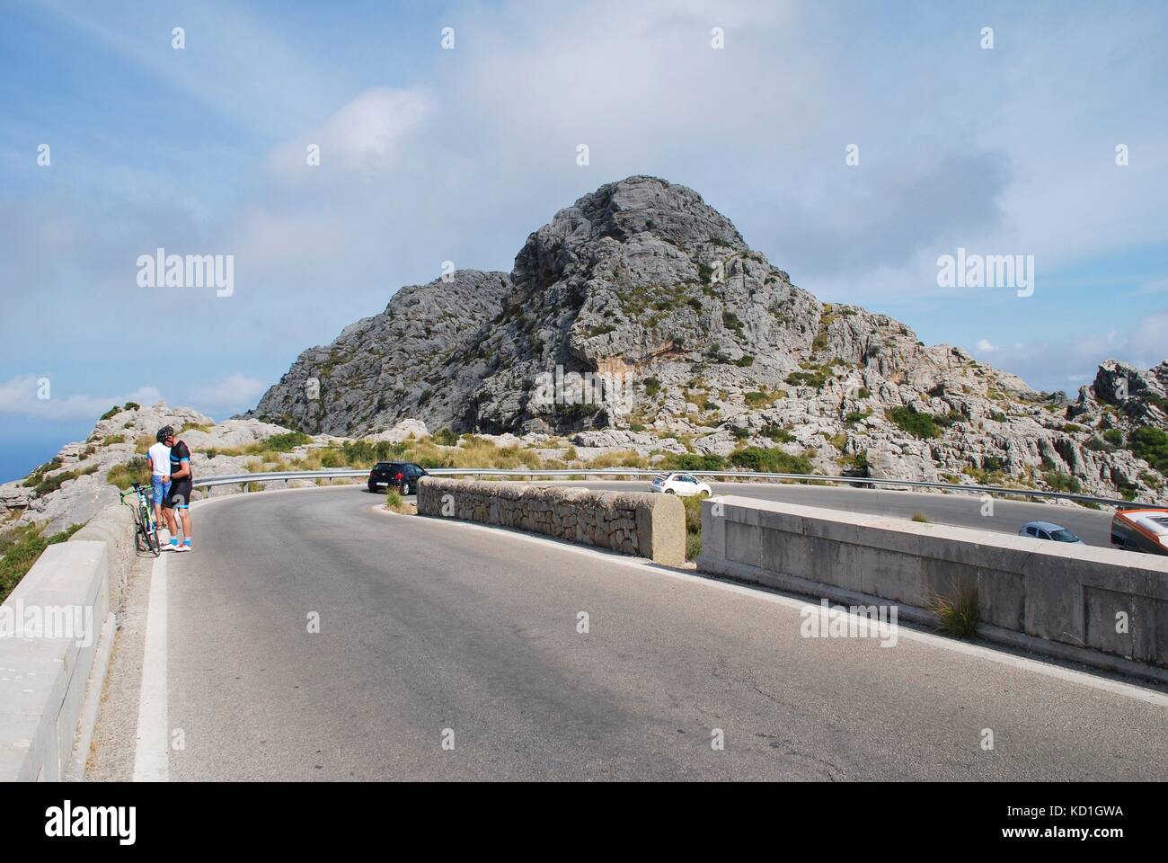 Cyclists and cars on the twisting road to Sa Calobra high up in the Tramuntana mountains on the Spanish island of Majorca on September 6, 2017. Stock Photo