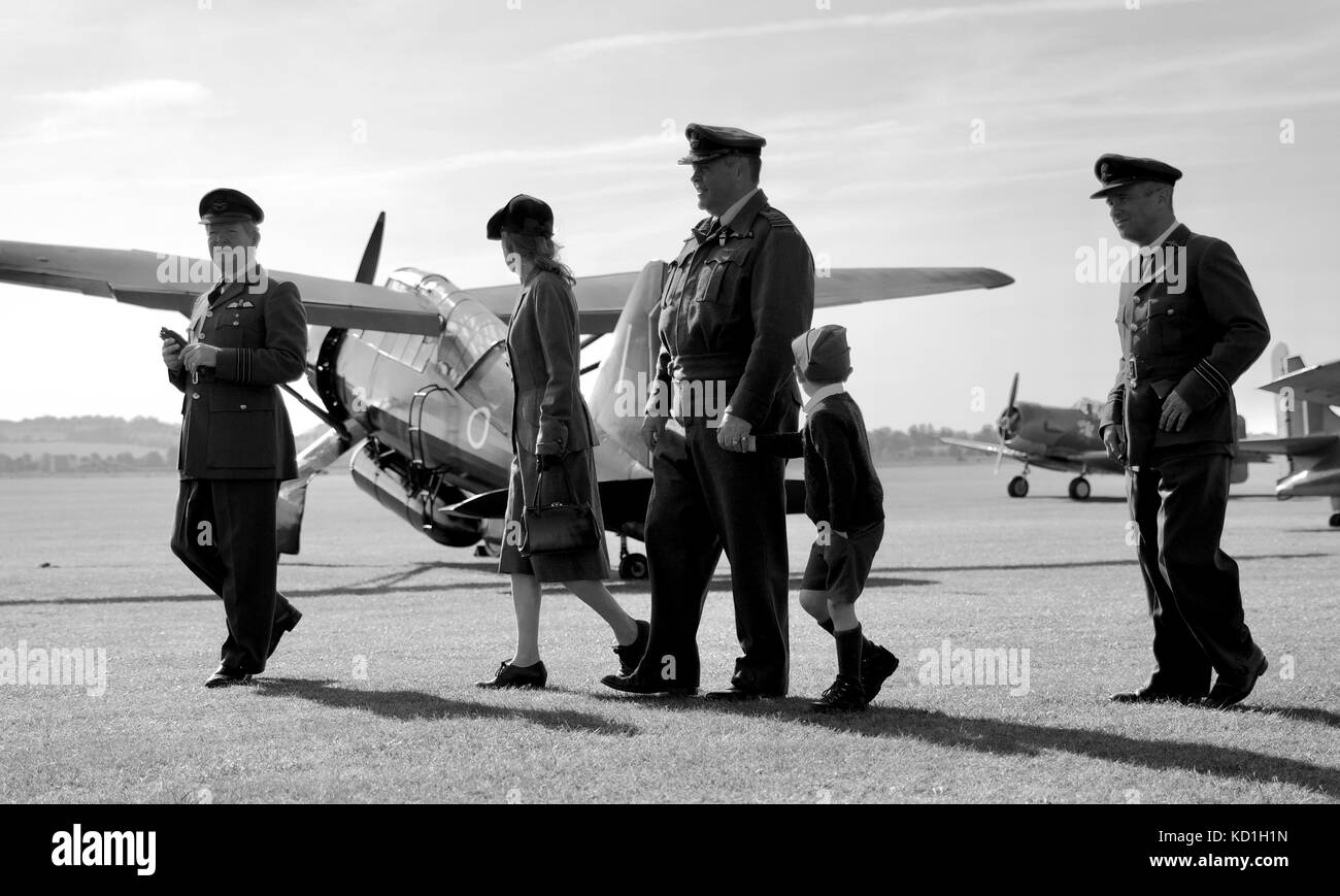 People dress in period uniform at Duxford Battle of Britain Air Show with a 1938 Westland Lysander in the background Stock Photo