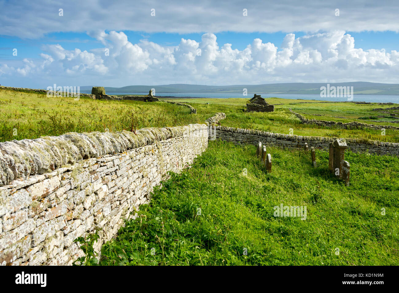 The ruined Skaill Farm and Eynhallow Sound, from St. Mary's Church graveyard on the Westness Heritage Walk, Rousay, Orkney Islands, Scotland, UK. Stock Photo