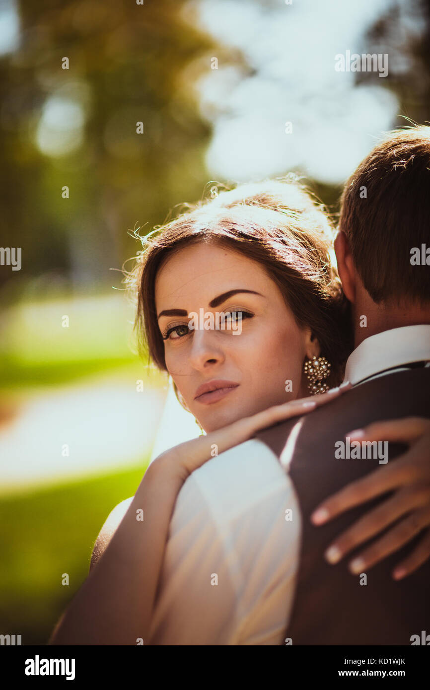 The bride and groom in the background of the park Stock Photo - Alamy