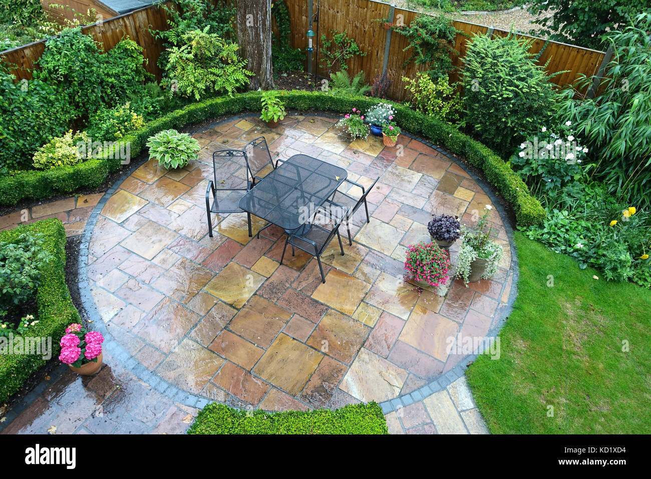 English patio in the rain on a wet summers day Stock Photo Alamy