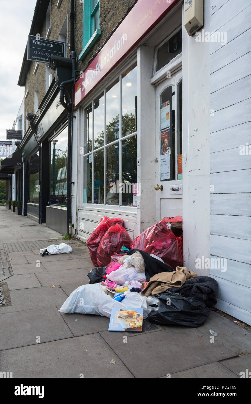 Bags of clothes dumped outside a charity shop in London, England, UK Stock Photo
