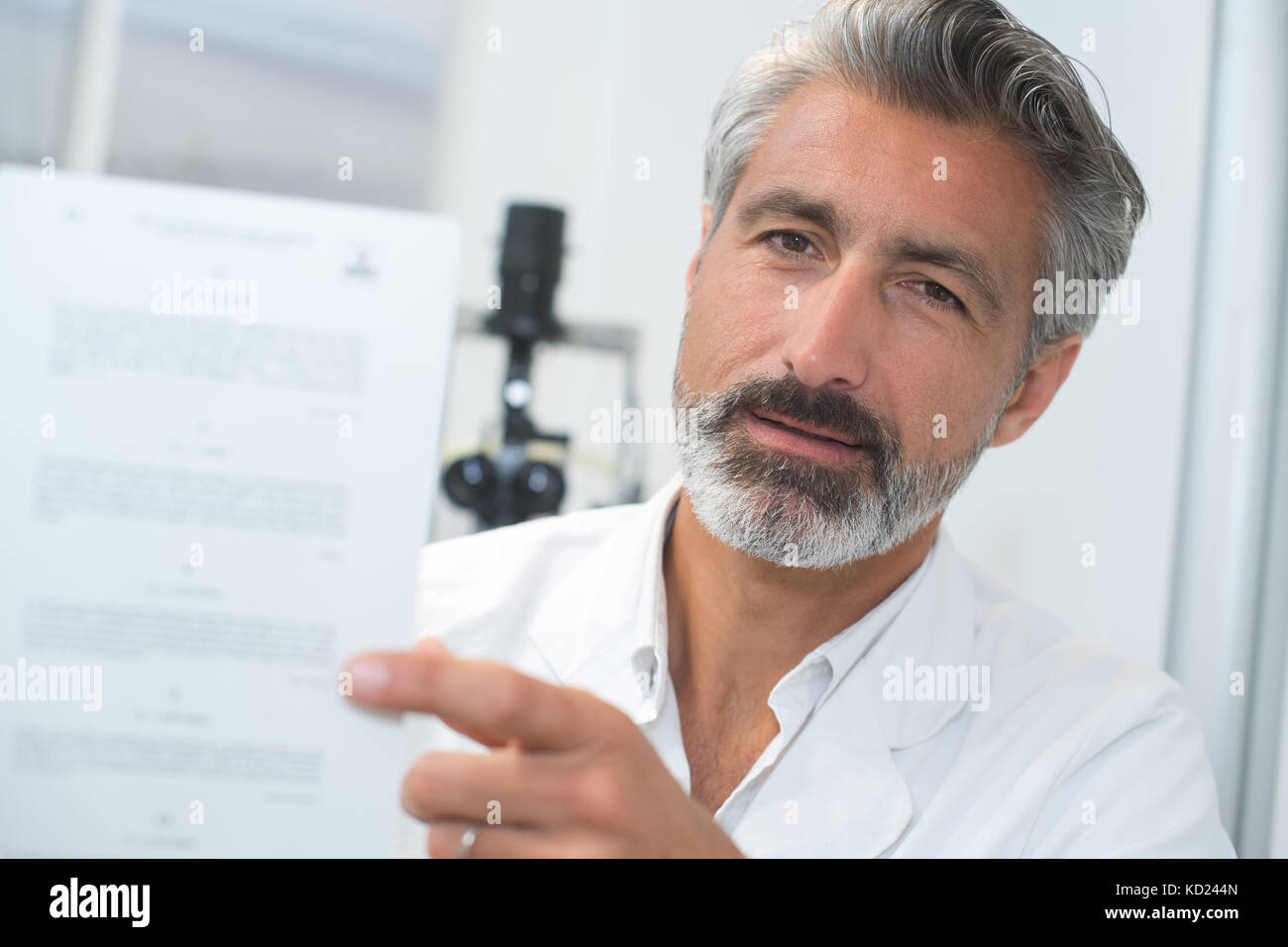 middle age optician holding eye chart Stock Photo