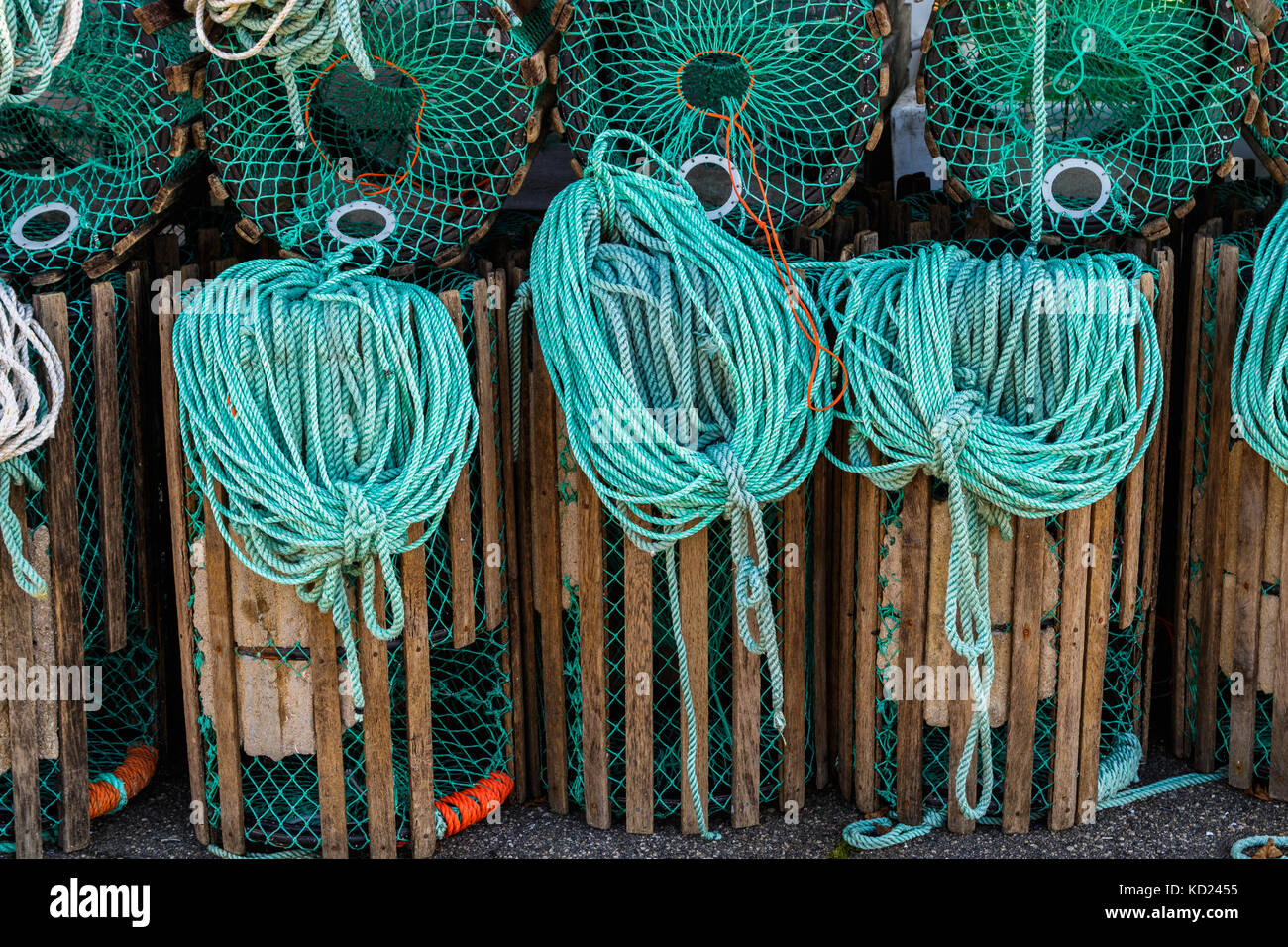 Lobster traps standing on a pier prepared for fishing with ropes and ...