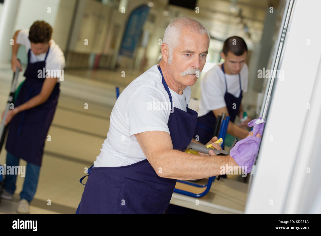 male janitors vacuuming corridor office Stock Photo Alamy