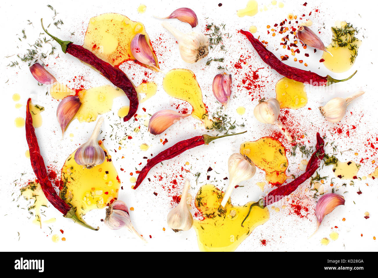 Pattern from spices on white - dried pepper, garlic and greens, oiled ...