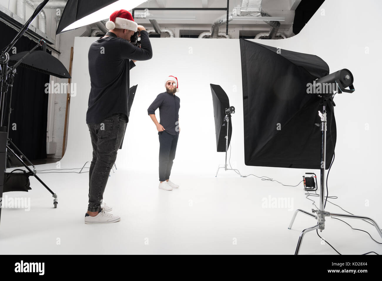 photographer working in studio with model Stock Photo