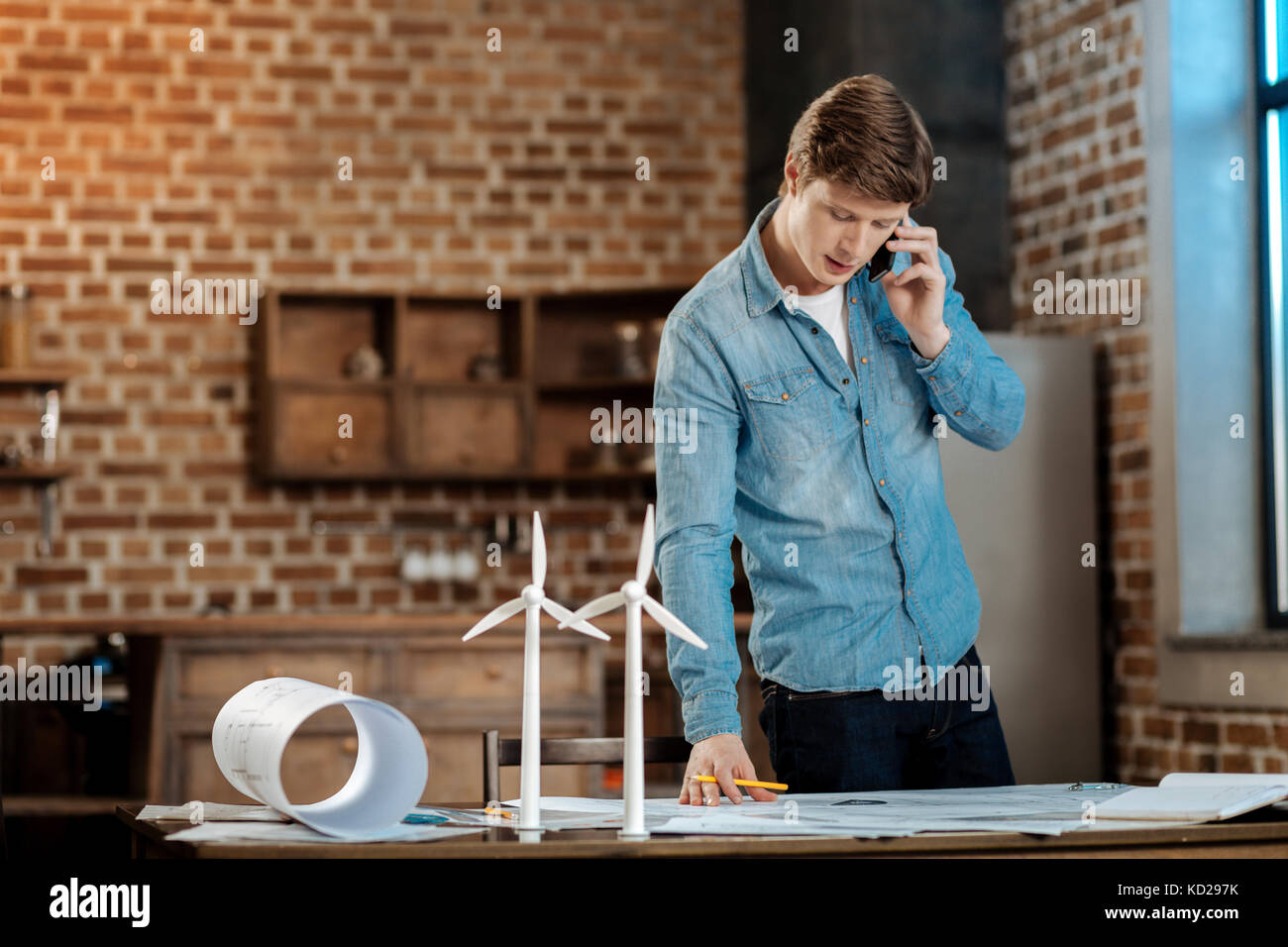 Young engineer discussing blueprint with his boss Stock Photo - Alamy