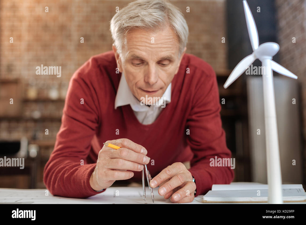 Senior engineer drawing circles with a compass Stock Photo - Alamy