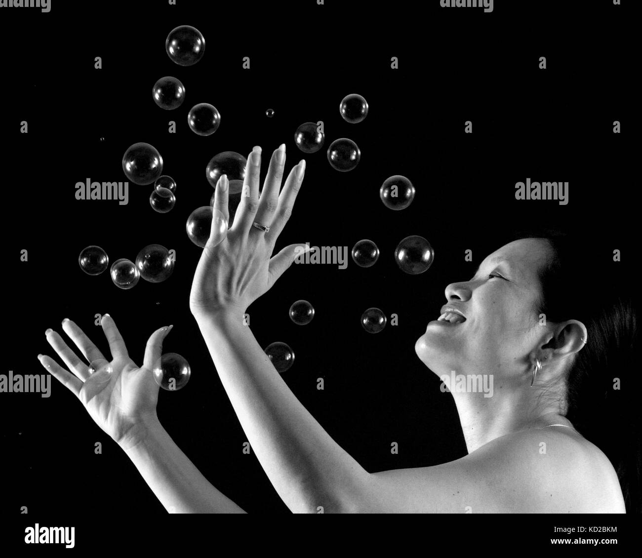 Chinese woman playing with blow bubbles Stock Photo