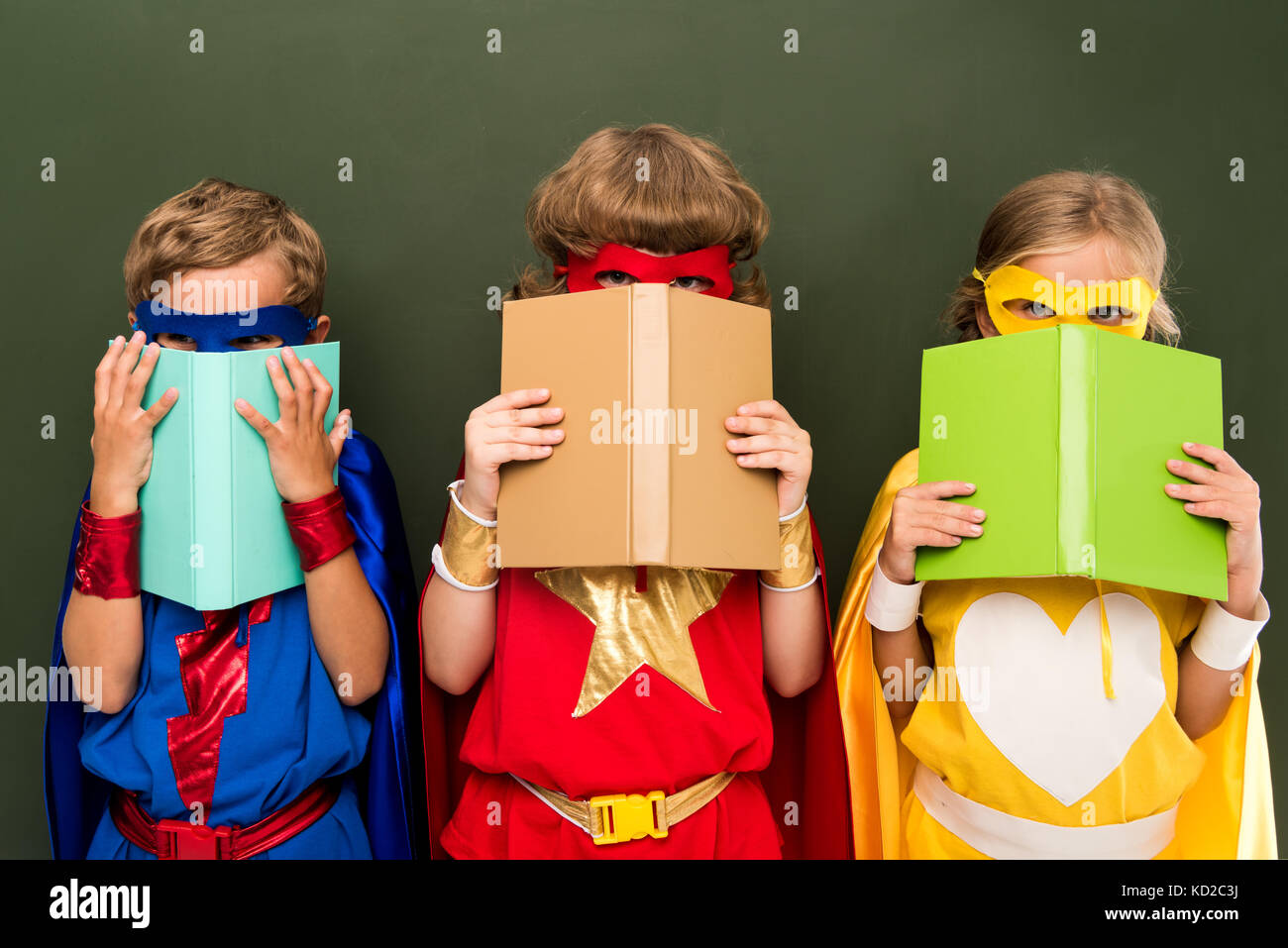 little superheroes with books Stock Photo