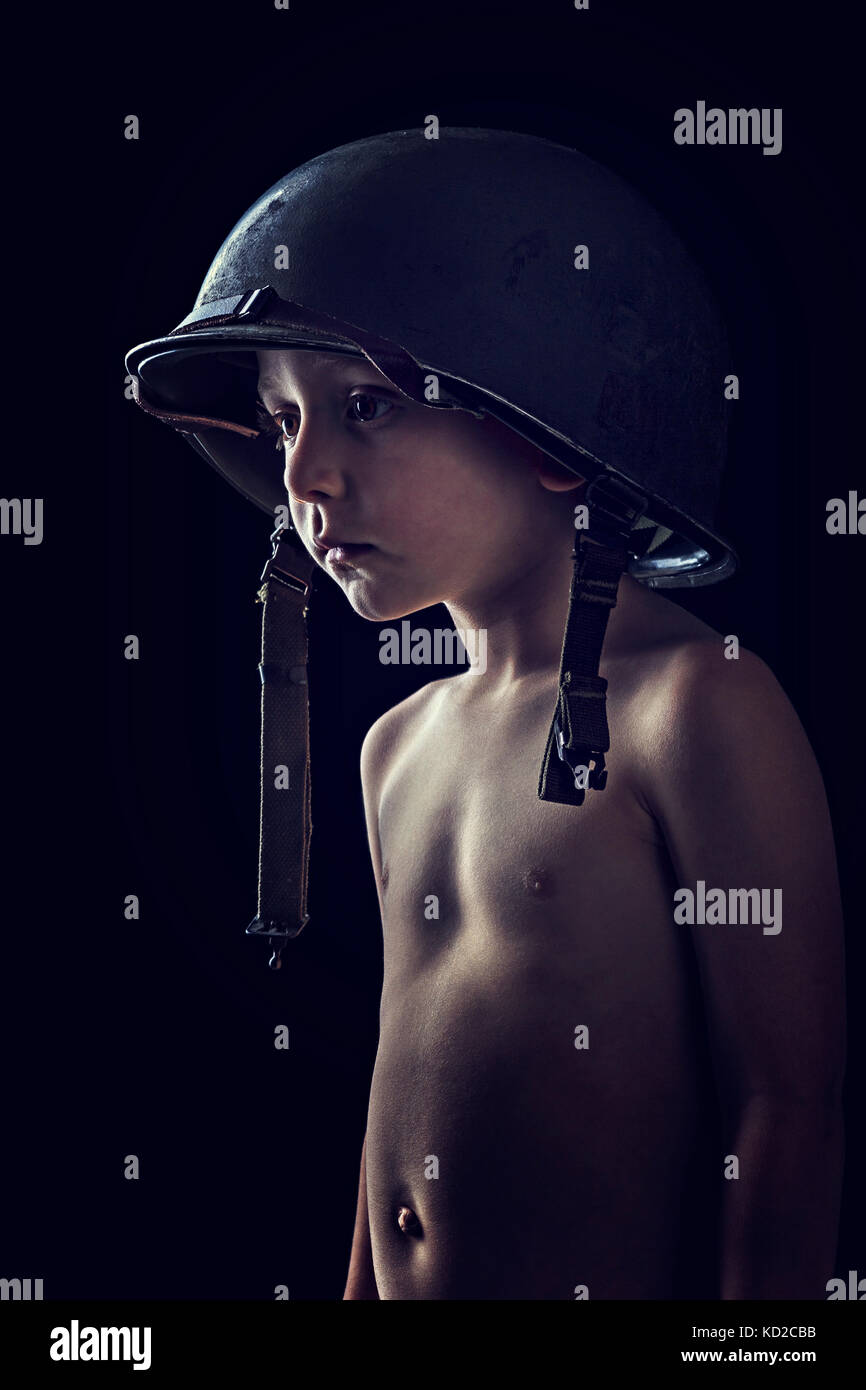 portrait of little soldier on black background Stock Photo