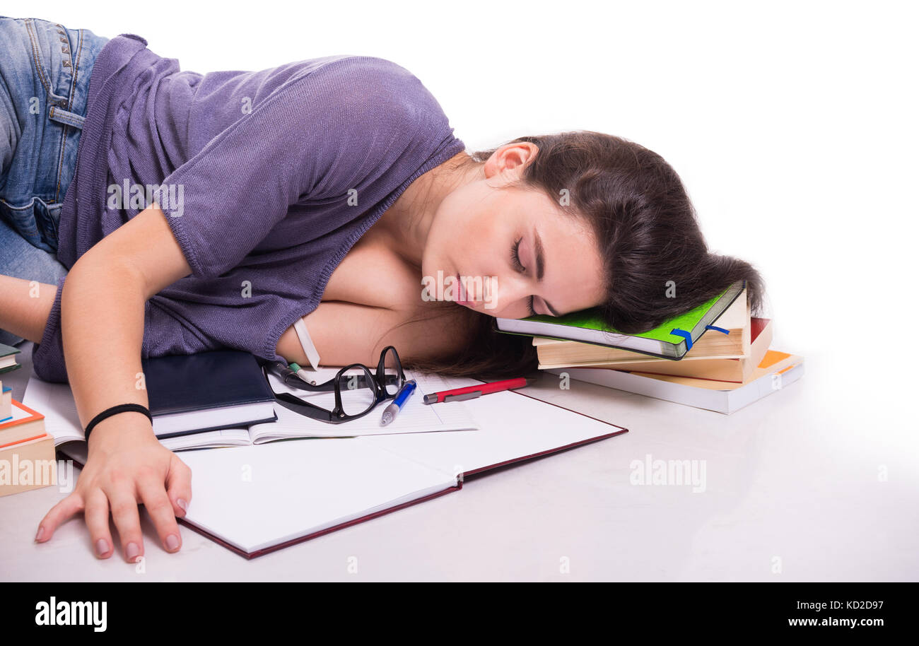 Image showcasing Student falling asleep on her books after studying hard for the next ...